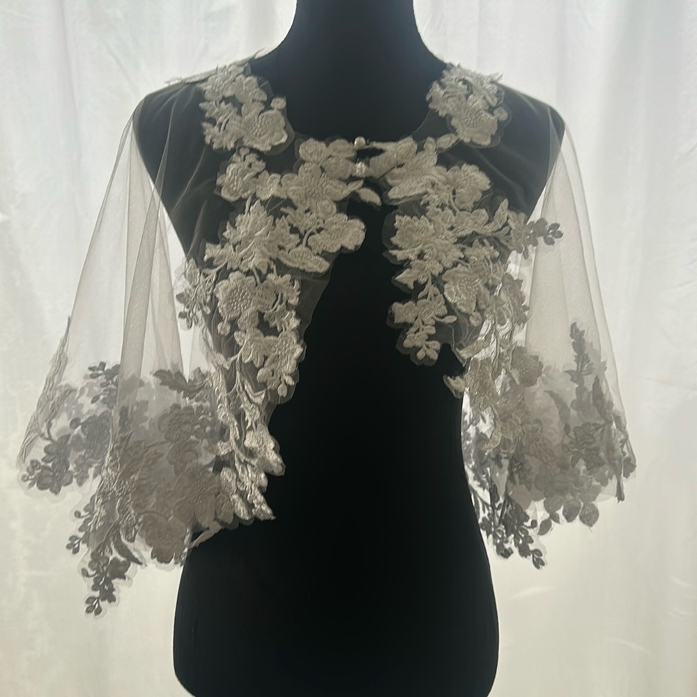 White beautiful cape with white flowers sticking